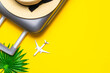Leinwandbild Motiv Suitcase, sunglasses with palm leaves and straw hat, white plane in travel composition on yellow background. Design of summer vacation holiday concept.
