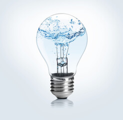 light bulb with water splashes on light background. alternative energy source