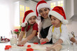 © New Africa - Mother and her cute little children making Christmas cookies in kitchen