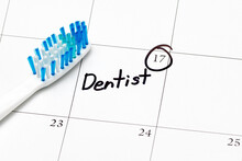 Dentist Appointment Reminder On Calendar With Toothbrush. Concept Of Oral Health, Exam And Teeth Cleaning