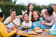 © Marcos - Latin woman happy birthday celebration garden party outside in the backyard in Mexico City