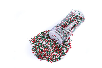 Sticker - Red white and green sprinkles heaping amount spilled from a container with a shaker lid