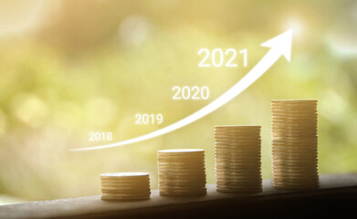 Growth in 2021 year concept. Business graph with arrow up. Growing money coins stack.