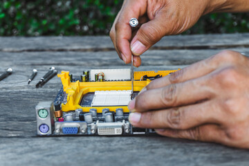 Wall Mural - Closeup hand of technician repairs or fixing and upgrade board computer pc of the motherboard. Computer service shop center concept.