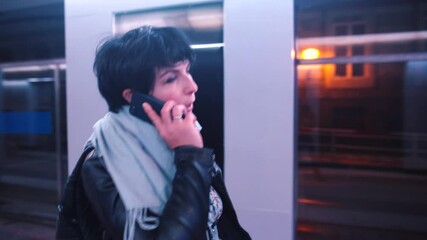 Poster - Woman talking on the phone making steps in the evening city. Transfer of a joyful message using the telephone network.
