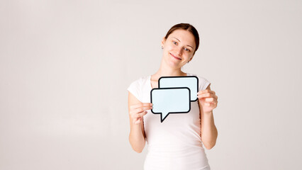 Canvas Print - Woman shows sign speech bubbles. Speech bubble banner. Happy girl hold empty speech bubbles.