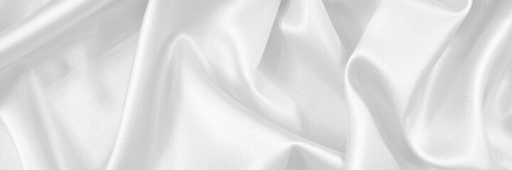Wall Mural - White silk satin fabric. White elegant background. Dark liquid wave or black silk with wavy folds. Beautiful white background with copy space for your design. Banner.