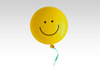 Yellow balloon with smile on white background - Concept of optimism and positive thinking
