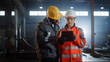 © Gorodenkoff - Two Heavy Industry Engineers Stand in Steel Metal Manufacturing Factory, Use Digital Tablet Computer and Have a Discussion. Black African American Industrial Specialist Talk to Female Technician.