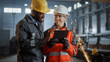 © Gorodenkoff - Two Heavy Industry Engineers Stand in Steel Metal Manufacturing Factory, Use Digital Tablet Computer and Have a Discussion. Black African American Industrial Specialist Talk to Female Technician.