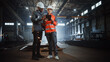 © Gorodenkoff - Two Heavy Industry Engineers Stand in Steel Metal Manufacturing Factory, Use Digital Tablet Computer and Have a Discussion. Black African American Industrial Specialist Talk to Female Technician.