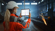 © Gorodenkoff - Professional Heavy Industry Engineer Uses Tablet Computer for Checking Metal Gear Blueprints in Interactive CAD Software. Female Industrial Specialist Working in a Metal Manufacture Warehouse.