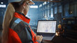 © Gorodenkoff - Professional Heavy Industry Engineer Uses Laptop Computer with CAD Software to Check Metal Gear Blueprints. Female Industrial Specialist Working in a Metal Manufacture Warehouse.