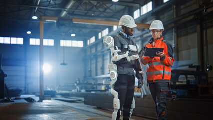 Poster - Futuristic Concept of a Manual Labor Worker in a Bionic Exoskeleton Prototype Working in a Factory. Heavy Industry Engineer Monitors the Powered Suit on an African American Assistant.