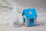 Fototapeta Mapy - Miniature glas christmas tree and winter house made of paper, handmade, close-up on a light background