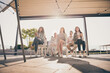 © deagreez - Portrait of attractive cheery entrepreneurs sitting listening speaker clapping palms development on roof fresh air outside outdoor