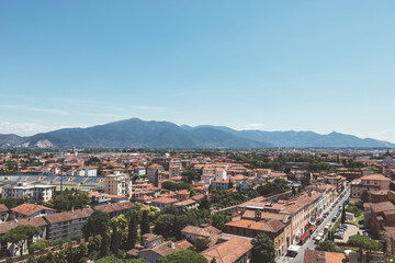 Wall Mural - Panoramic view of Pisa city with historic buildings and far away mountains