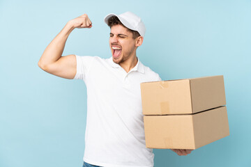 Wall Mural - Delivery caucasian man isolated on blue background celebrating a victory