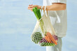 © Maki Company Limited/Stocksy - Male hands hold eco bag of vegetables