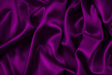 Wall Mural - Purple silk satin fabric. Elegant abstract background in magenta colors. Liquid wave or silk wavy folds. Beautiful background with copy space for your design.