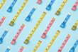 © Yaroslav Danylchenko/Stocksy - Colorful measure tapes pattern.