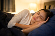 © tonefotografia - A young woman is sleeping in her bedroom , health and home safety concept .