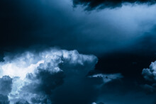 White Clouds Against A Dark Bright Blue Sky. Cloudy Wallpaper For News About Weather Forecast. Before A Thunderstorm And Hurricane Or Storm. The Power And Strength Of Nature. Air Element. Religion
