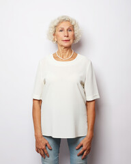 Mature woman with white hair in studio and white background