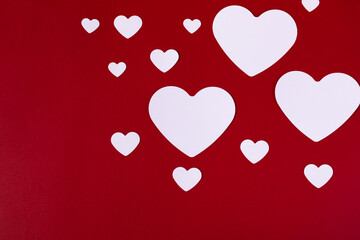 Poster - Top view shot of cute pink papers in a heart shape on a red background