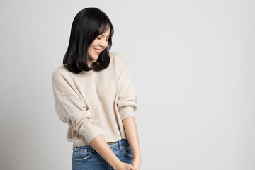 Beautiful young asian woman smiling and happy. Charming female standing on isolated white background.