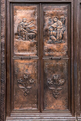 Canvas Print - Brass door with bas reliefs captured at St Joseph's cathedral in the old quarter of Hanoi, Vietnam