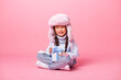 © КРИСТИНА Игумнова - Cute little Asian girl in a winter hat and sweater holds a gift box. Christmas concept, text space