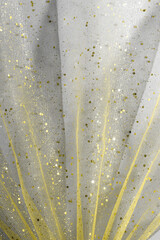 Wall Mural - Illuminating yellow draped tulle with glitter on Ultimate Gray background. Color of the year 2021