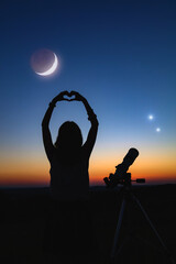 Wall Mural - woman looking at night sky with amateur astronomical telescope.