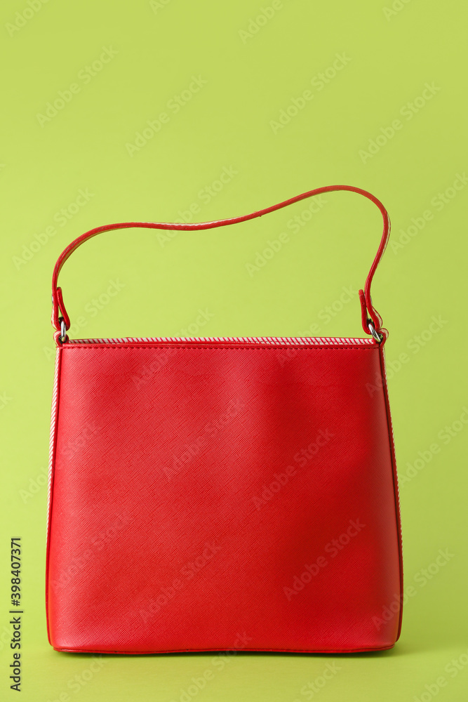 Stylish bag on color background