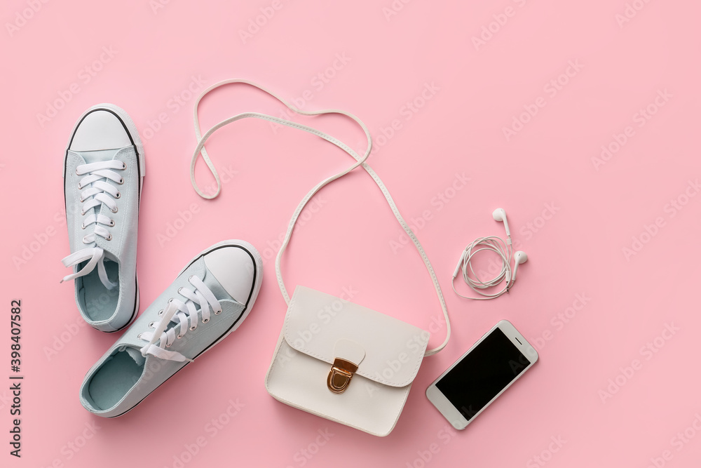 Stylish bag, mobile phone and shoes on color background