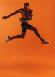 © Jacob Lund - Fit man working out on orange background