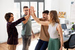 © Syda Productions - startup, success and people concept - happy business team making high five at office