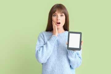 Sticker - Surprised young woman with e-reader on color background