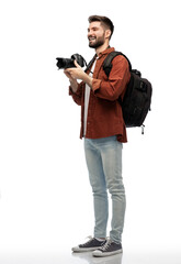 Wall Mural - photography, travel and people and concept - happy smiling man or photographer with digital camera and backpack over white background