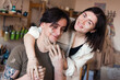 © shapovalphoto - Loving couple dating in pottery workshop, man and woman sit at the pottery wheel and modeling clay