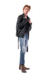© sharplaninac - Side view of confident young man in jeans and boots adjusting black leather jacket. Full body length isolated on white background.