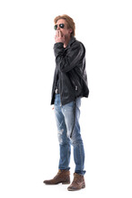 Side View Of Confident Man In Biker Or Rocker Style Clothes Smoking Cigarette Looking Away. Full Body Length Isolated On White Background. 