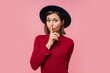 © Svetlana Sokolova - Cut pretty woman  put her finger to her lips, keep silence. People, body language concept. Pink background.