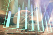 © peshkova - Double exposure of man's hands holding and using a phone and financial graph drawing. Analysis concept.