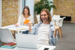 © zinkevych - Fair-haired young man sitting at the laptop and looking excited