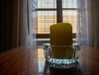 © RODRIGO - CANDLE IN GLASS BOWL, ON AN OLD TABLE, WHILE LIGHT ENTERS THROUGH THE WINDOW