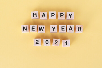 Wall Mural - Happy New Year 2021 on wooden block yellow background