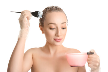 Canvas Print - Young woman applying dye on hairs against white background