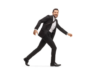 Sticker - Handsome man in a black suit running and looking at camera